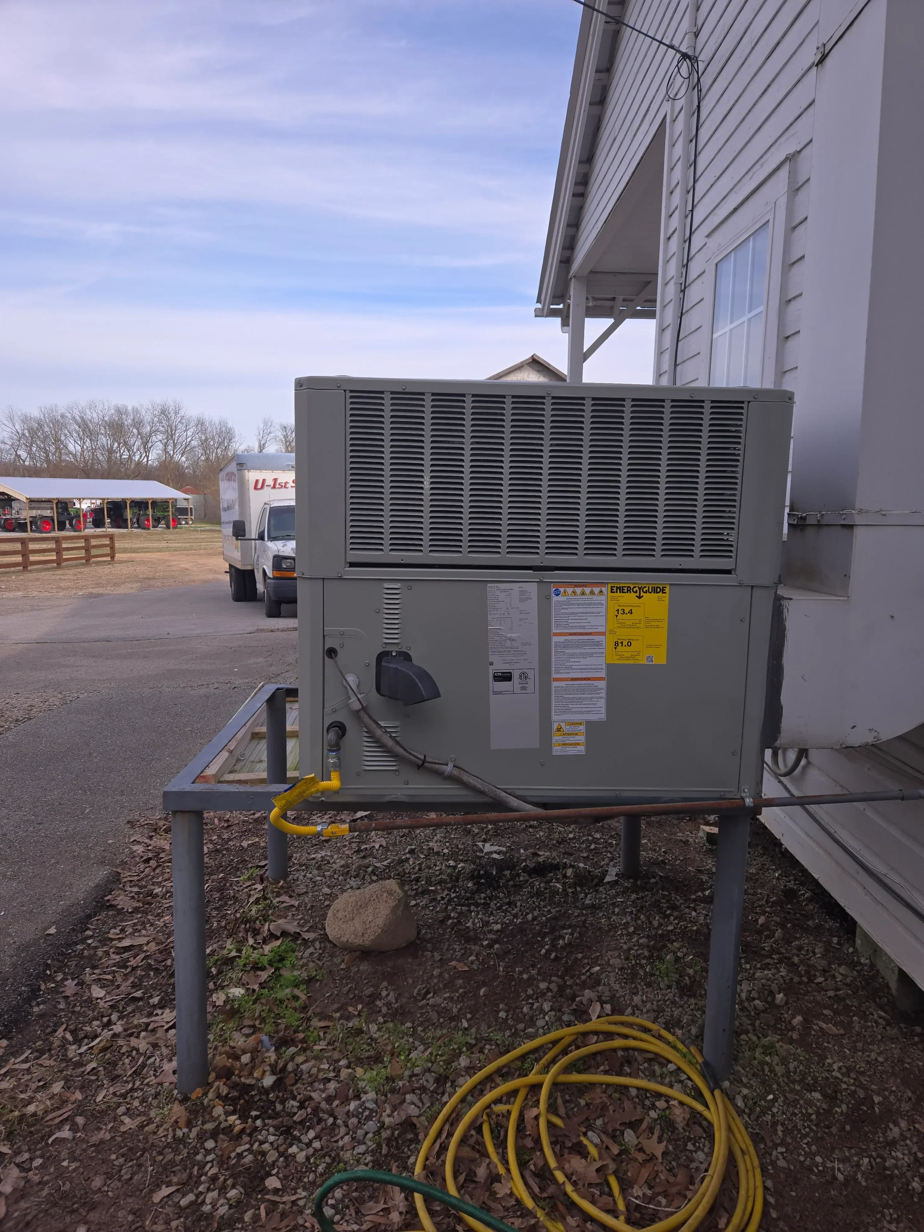 Commercial HVAC rooftop unit with metal frame, ventilation grille, and electrical connections