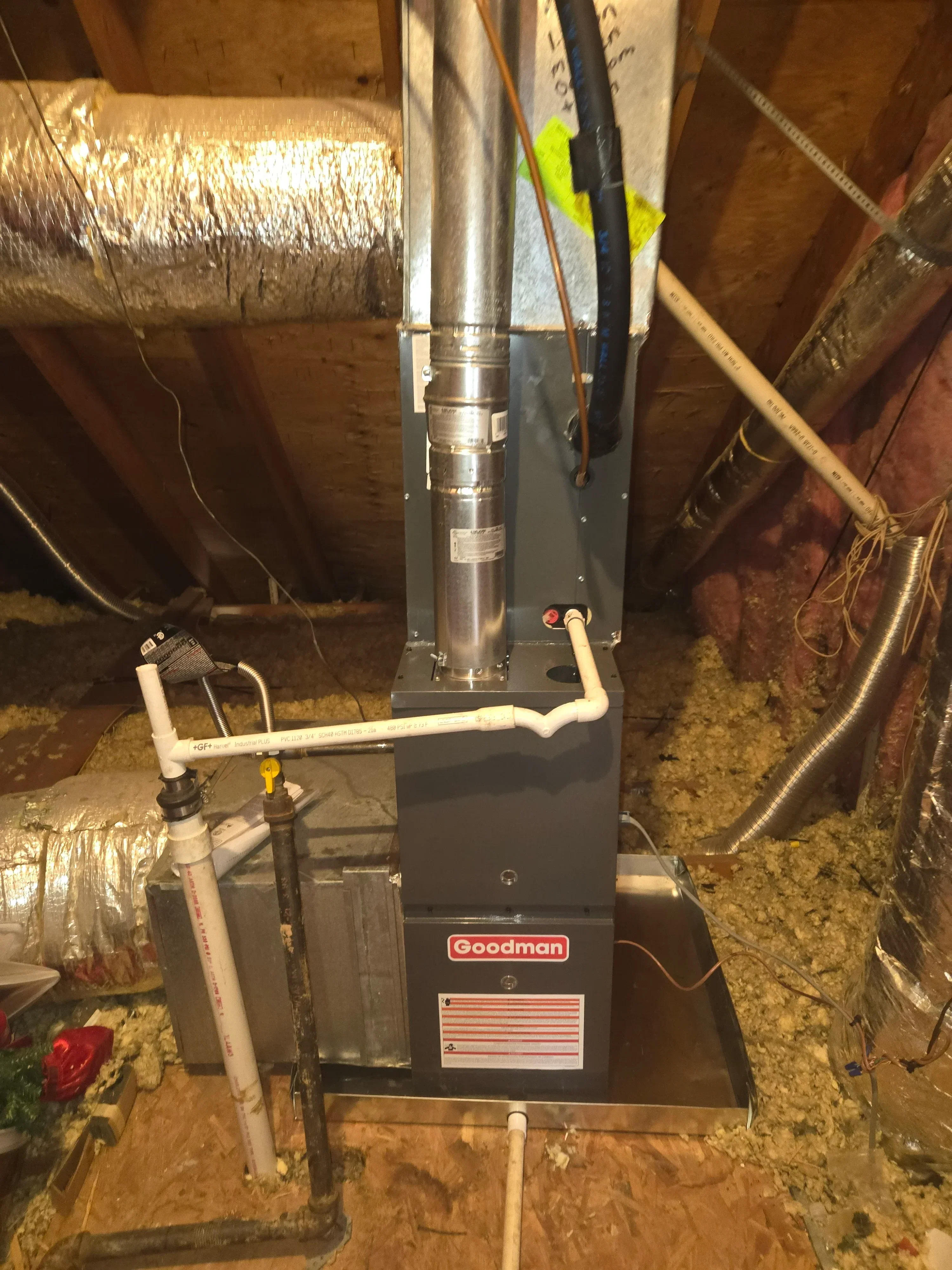 Goodman furnace with insulated ductwork, copper lines, and sealed connections in basement