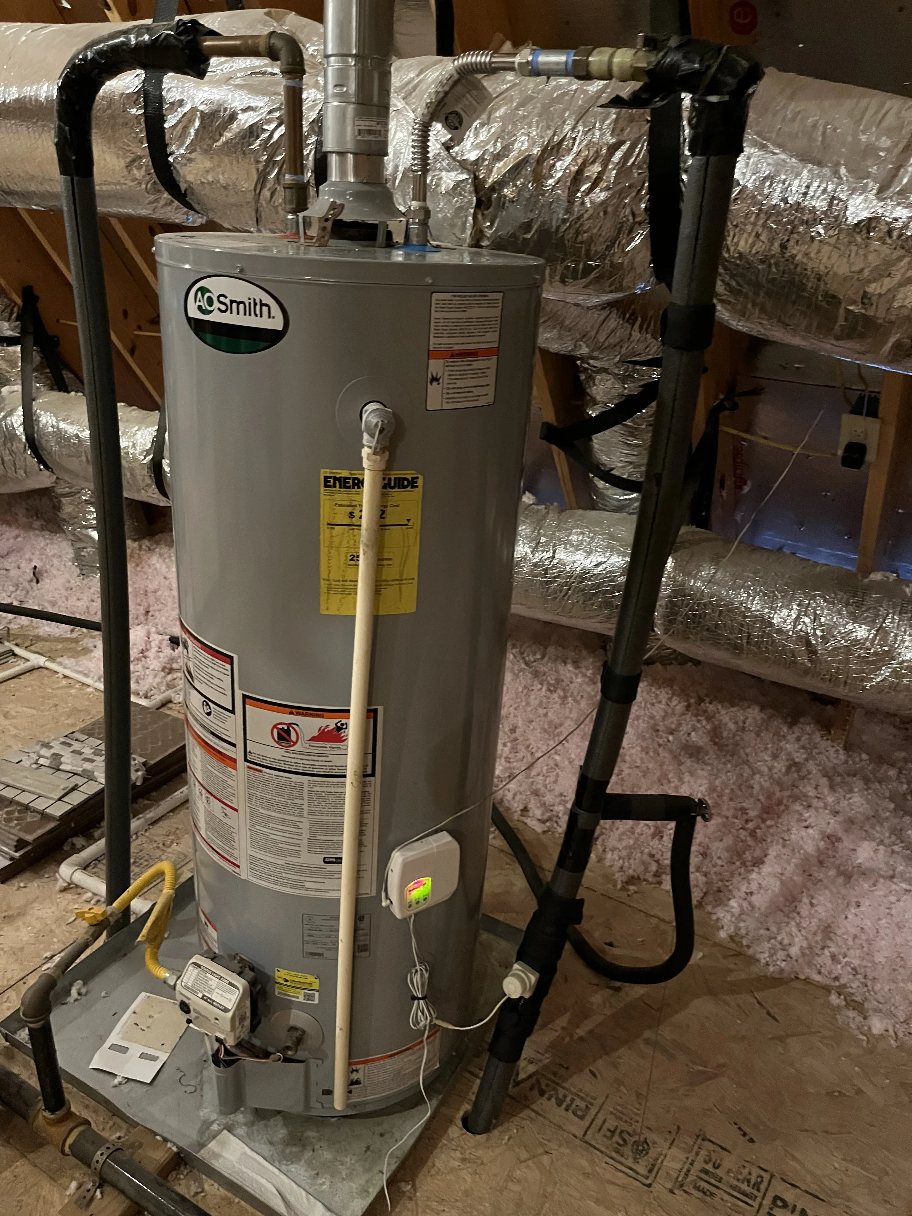 AO Smith gas water heater with black iron piping, insulated ducts, and electrical connections installed