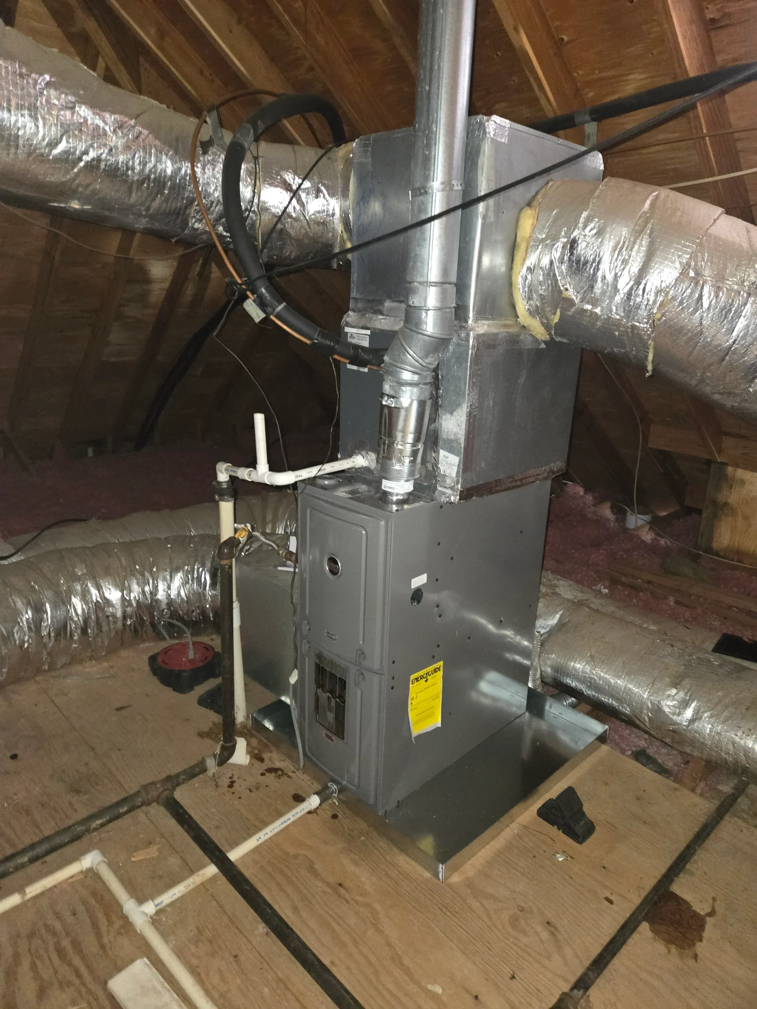 HVAC unit with insulated metal ductwork and sealed connections in attic installation